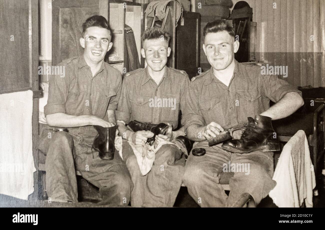 Three army recruits on National Service polishing their boots in their barracks, RAMC, 1956, Ash Vale, Surrey, England, UK Stock Photo