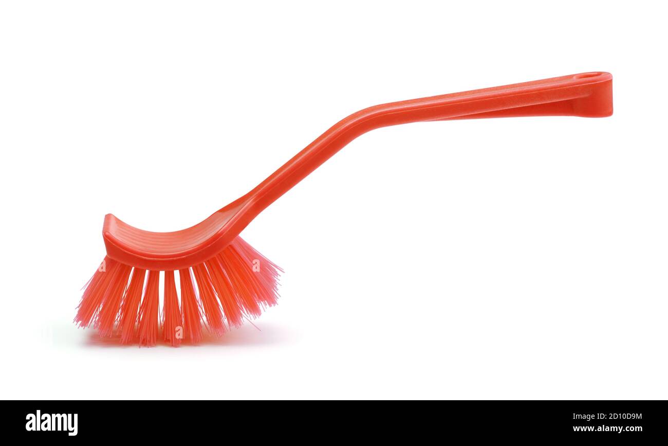 Red plastic dish brush isolated on white. Stock Photo
