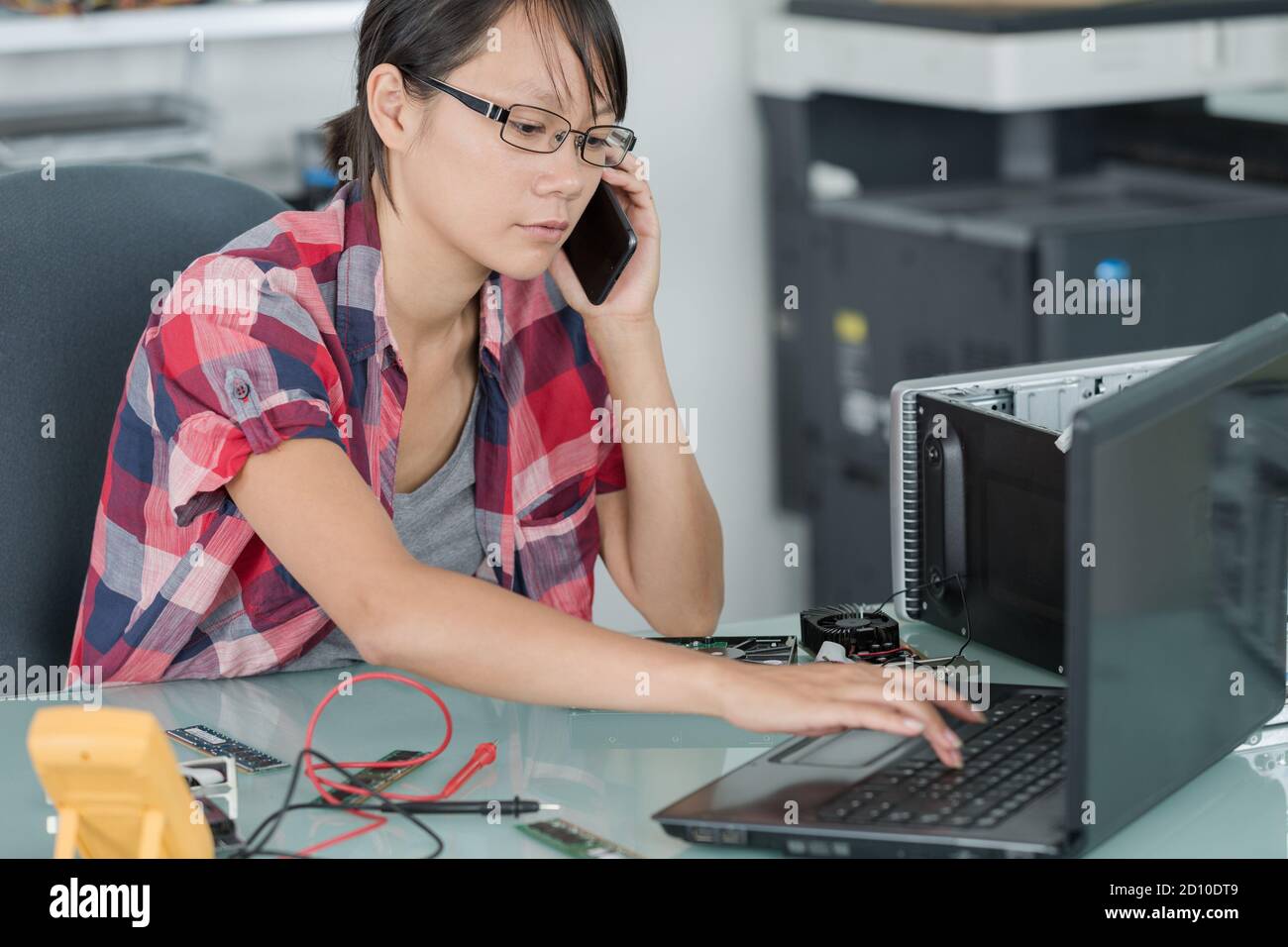 technician talking on phone in office Stock Photo