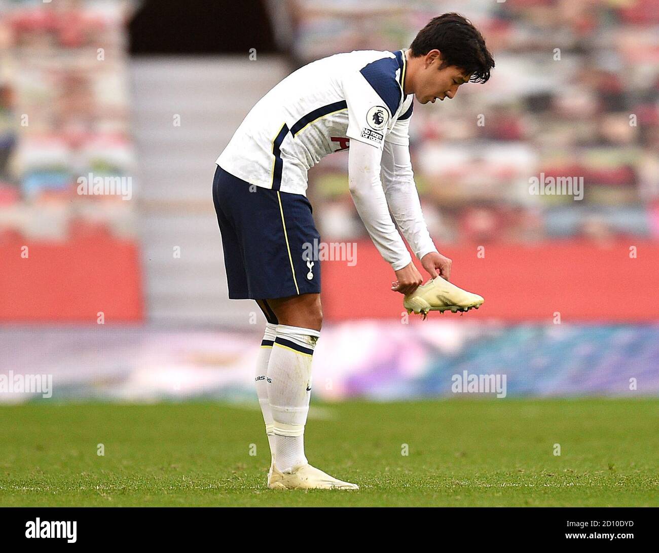 Tottenham Hotspur's Son Heung-min puts his boot back on after being fouled  by Manchester United's Eric Bailly (not pictured) during the Premier League  match at Old Trafford, Manchester Stock Photo - Alamy