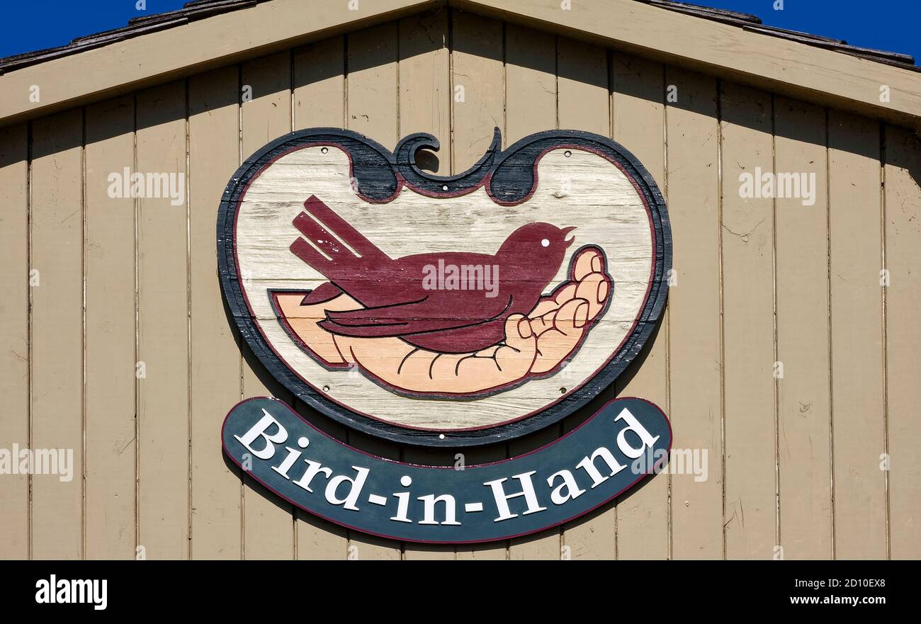 sign, village, hand holding bird, weathered wood, building, Lancaster