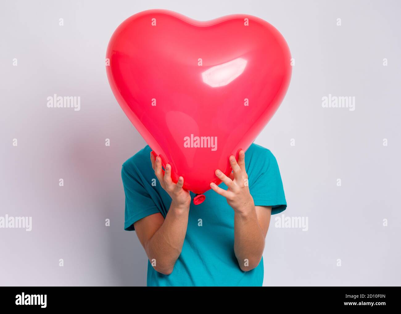Boy with heart shaped balloon Stock Photo