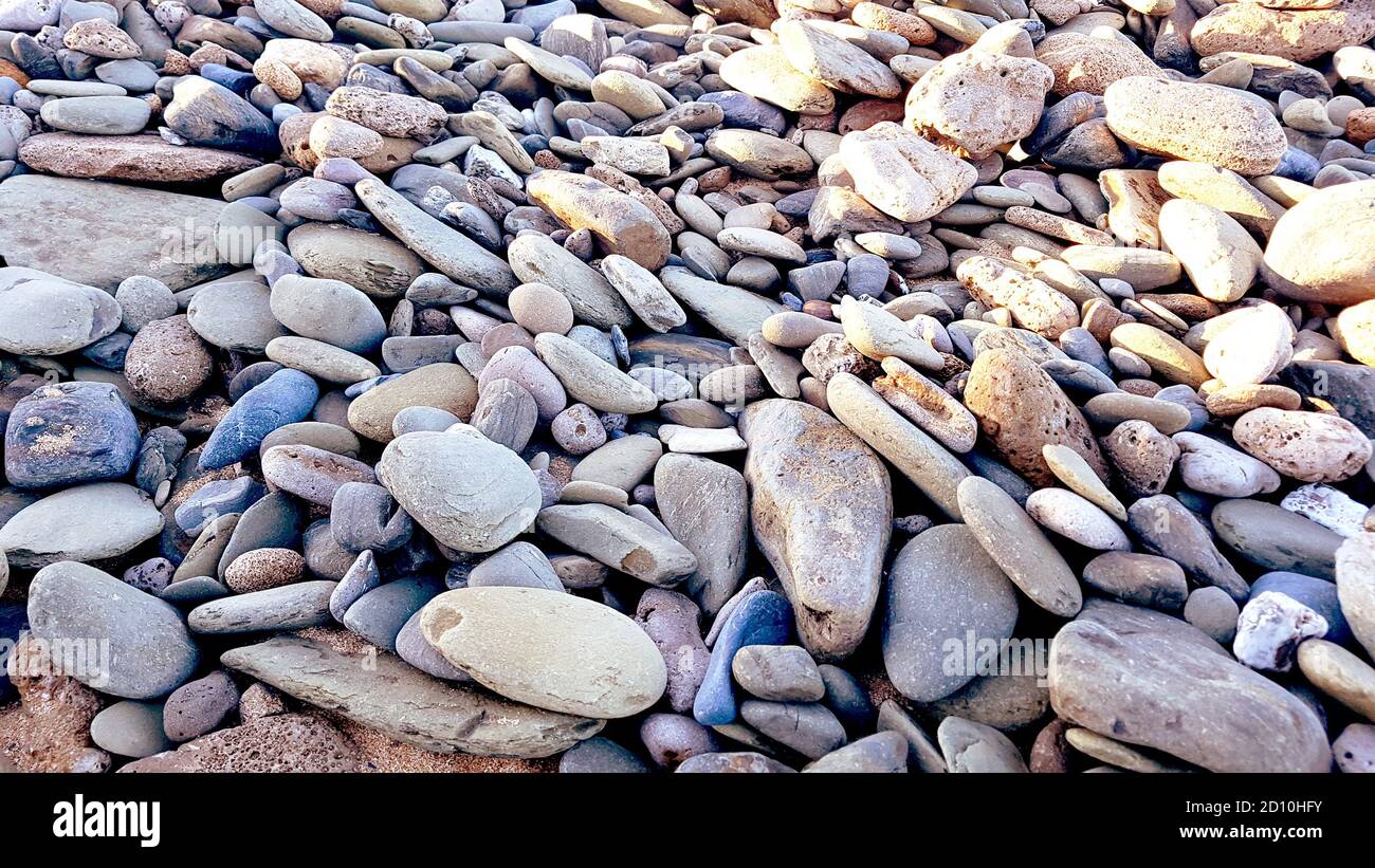 natural pebbles stone, grey gravel beach texture background. Stock Photo