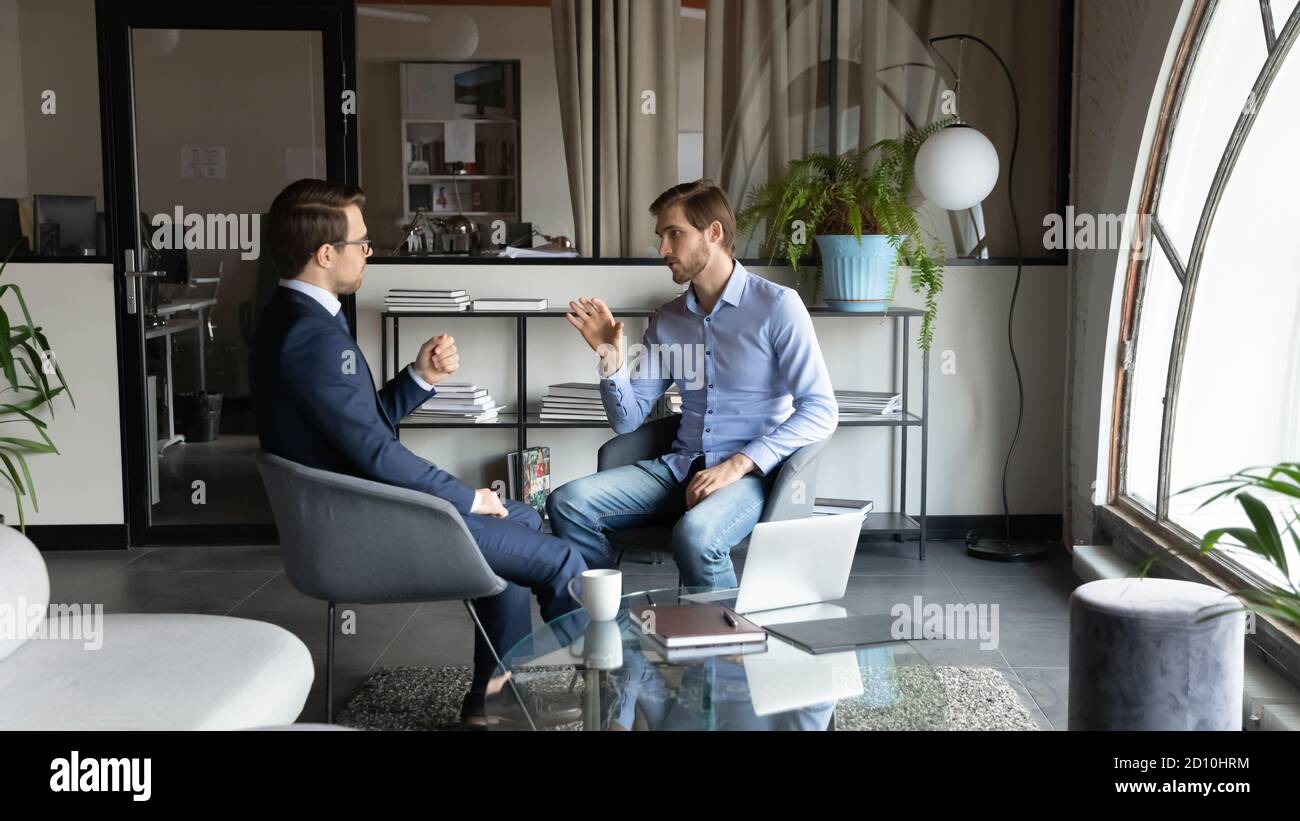 Two colleagues discussing project ideas in modern office. Stock Photo