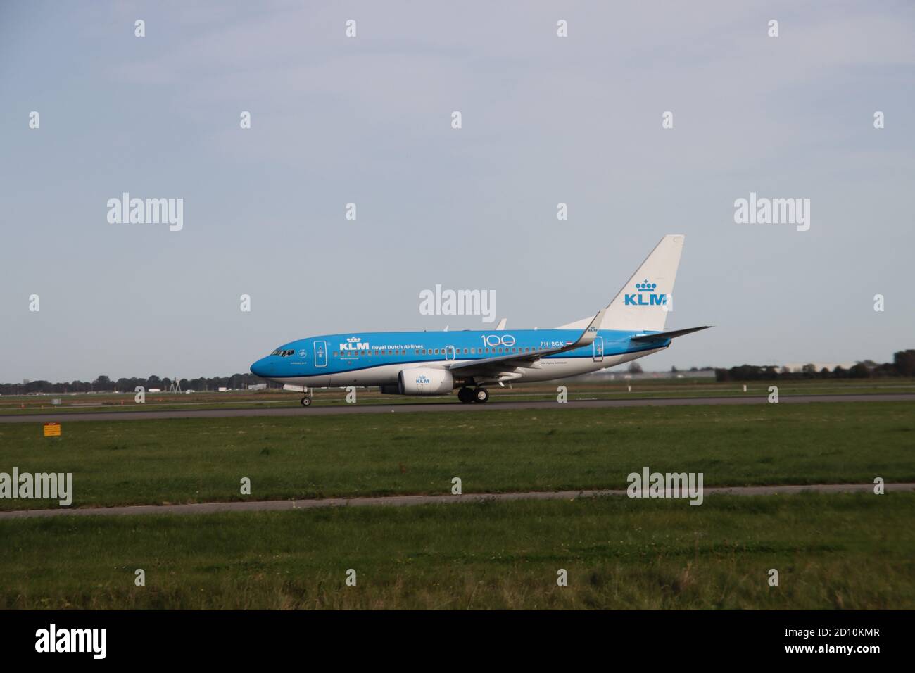 Boeing 737 type 700 of KLM is leaving Amsterdam Schiphol Airport in the Netherlands at the Polderbaan strip Stock Photo