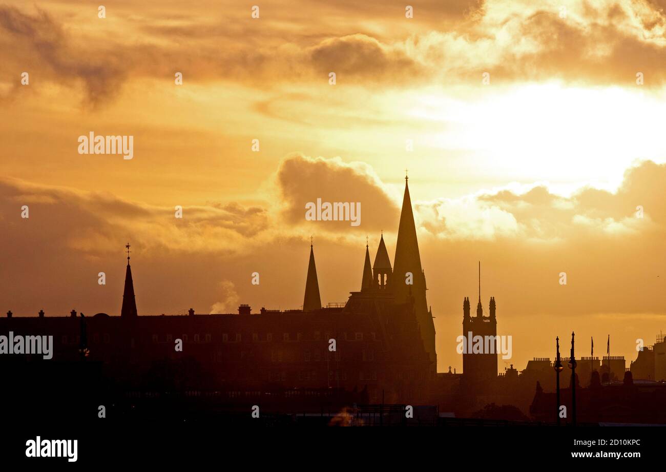 Edinburgh, Scotland, UK. 4 October 2020. Sunset over the west end of the city centre, highlighting the spires of St. John's and St Cuthbert's churches, dry weather with temperature 13 degrees. Stock Photo