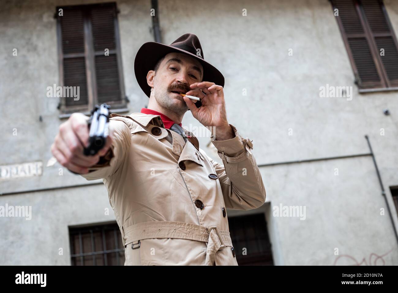 Hitman pointing the gun to the camera, execution concept Stock Photo