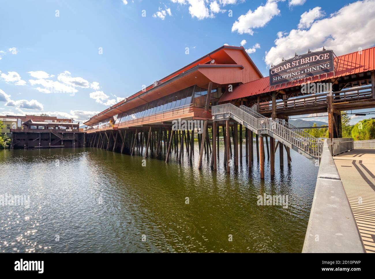 The Cedar Street Bridge Public Market of shopping and dining along Sand Creek River and Lake Pend Oreille in Sandpoint, Idaho, USA during summer. Stock Photo