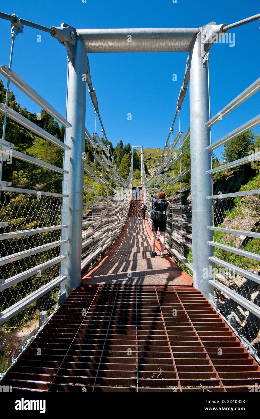 Suspension bridge over Plima river gorge in Martell Valley (Martelltal), Bolzano, Trentino-Alto Adige, Italy Stock Photo