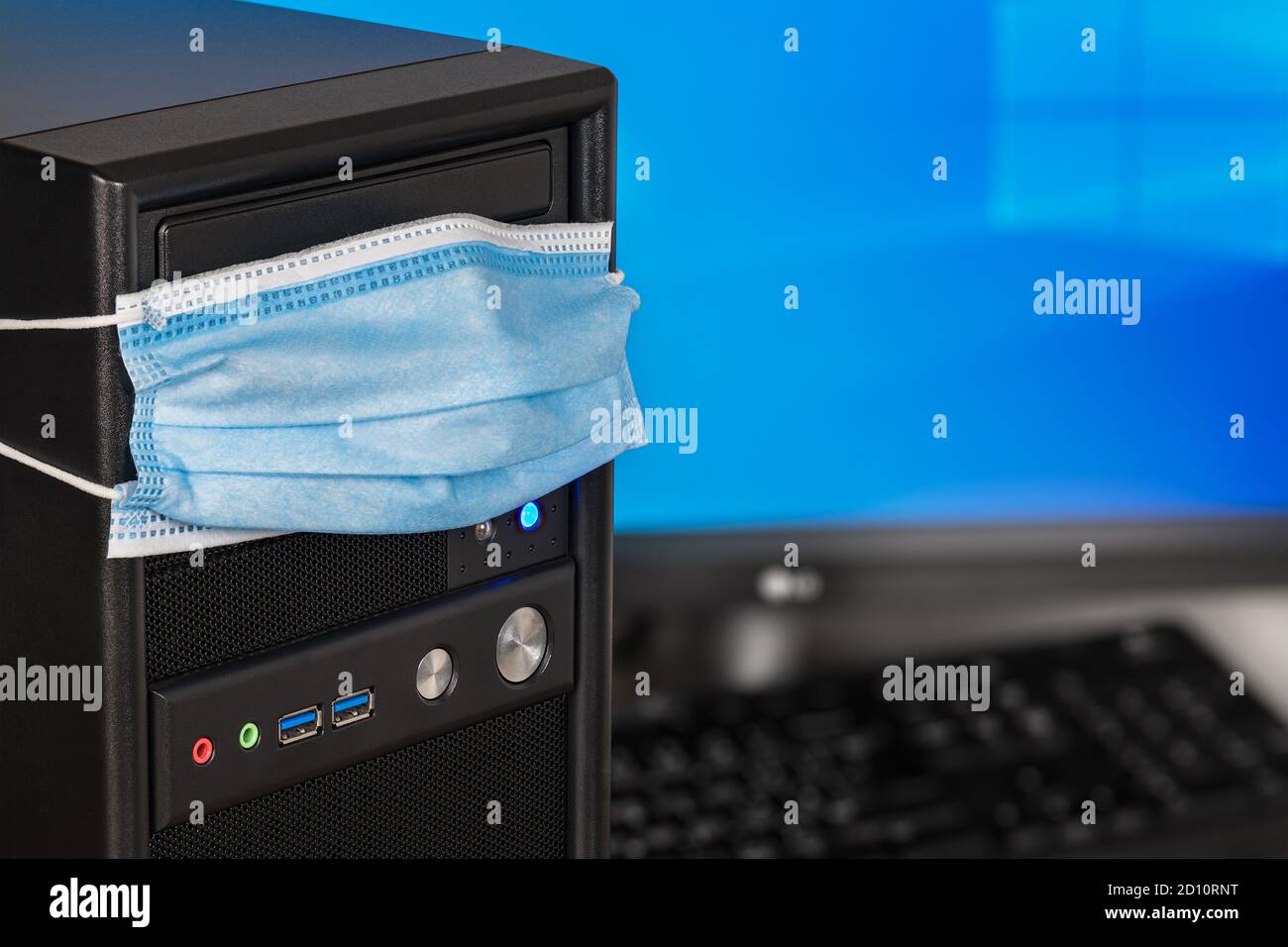 Coronavirus and antivirus protection concept. Computer weared in protective face  mask. Desktop PC with copy space on monitor detail. Online home work Stock  Photo - Alamy