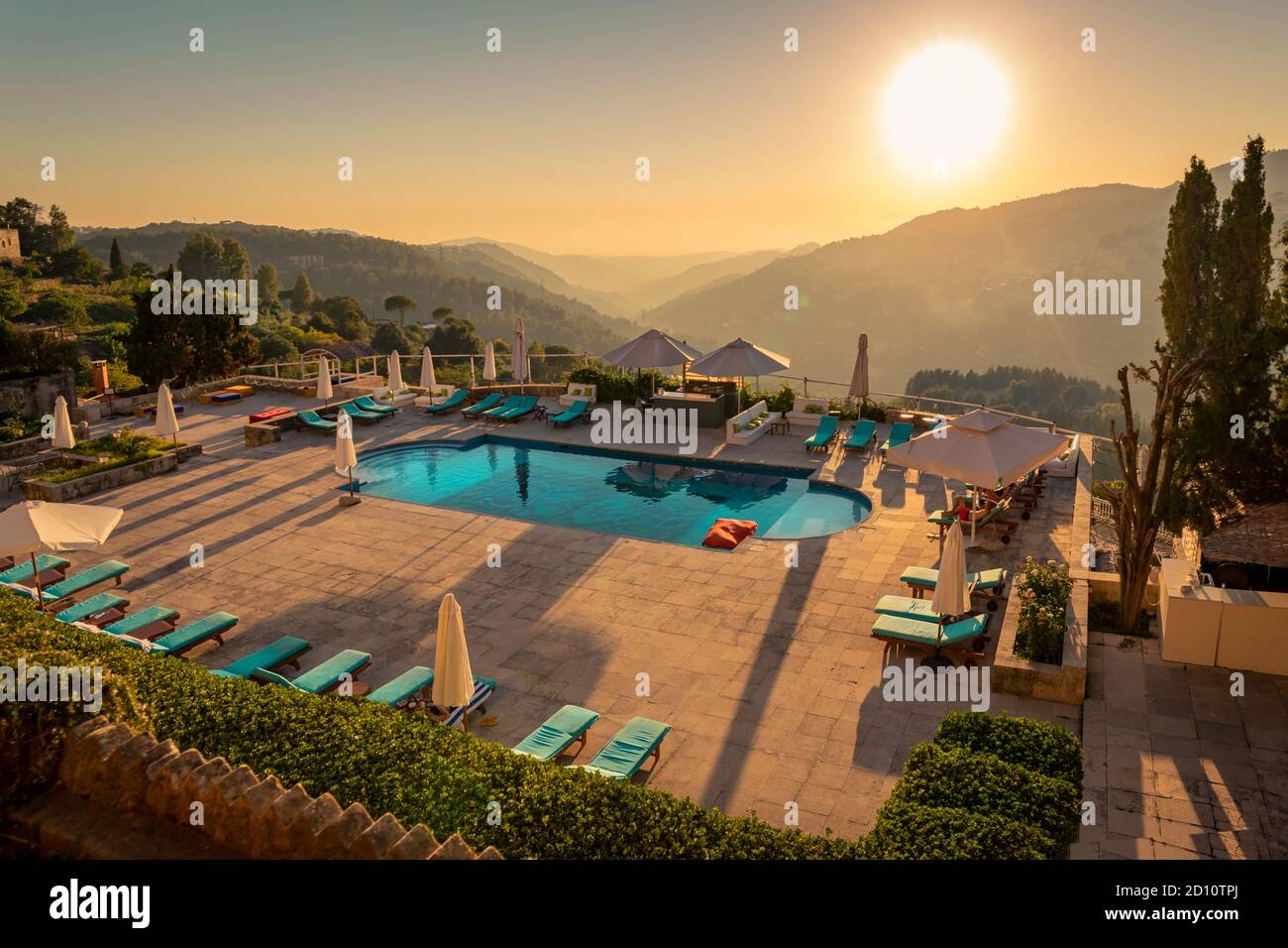 Traveling Lebanon. Pool with Refreshing Water in the Mild Sunset Light. Beautiful Resort in the Heart of the Mountains. Stock Photo