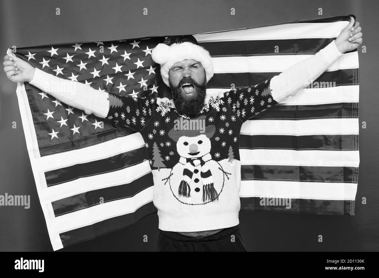 Holly jolly. Patriotic man celebrate xmas and new year. Happy santa hold american flag. Festive patriotic decoration. Patriotic holidays in USA. Christmas greetings from USA. Patriotic spirit. Stock Photo