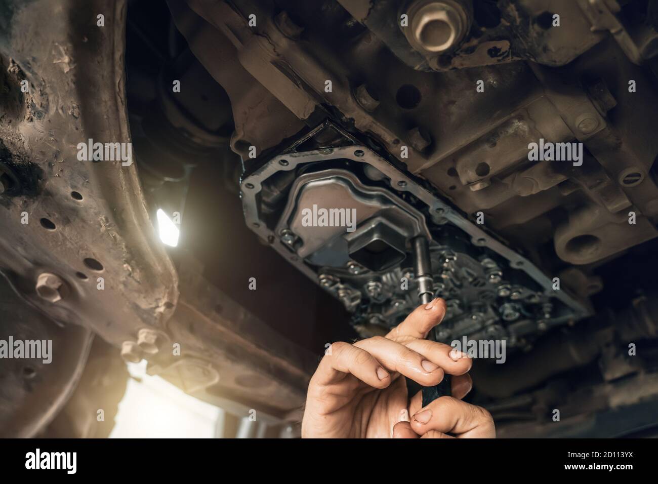 CVT gearbox close up, worker hands changing oil and making maintenance