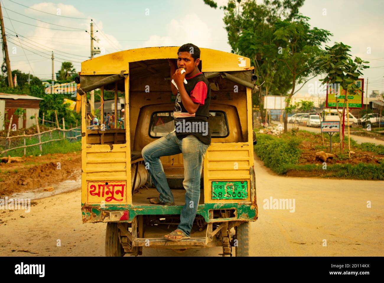 DHAKA, BANGLADESH- SEPTEMBER 30, 2020 : portrait of a local Bus contractor in Dhaka who was eating food in bus, working with ricks Stock Photo