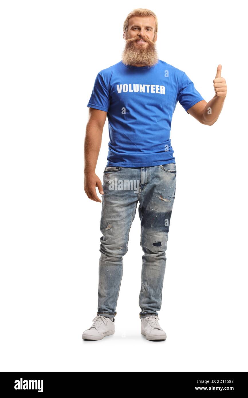Full length portrait of a young male volunteer with beard and moustache gesturing a thumb up sign isolated on white background Stock Photo