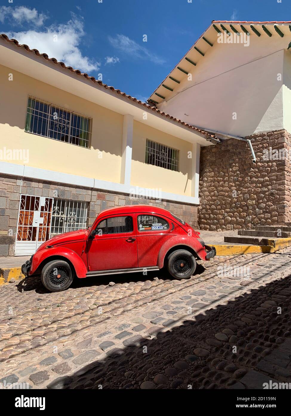 red retro car in the courtyard in Cusco, Peru. beautiful old auto. Stock Photo
