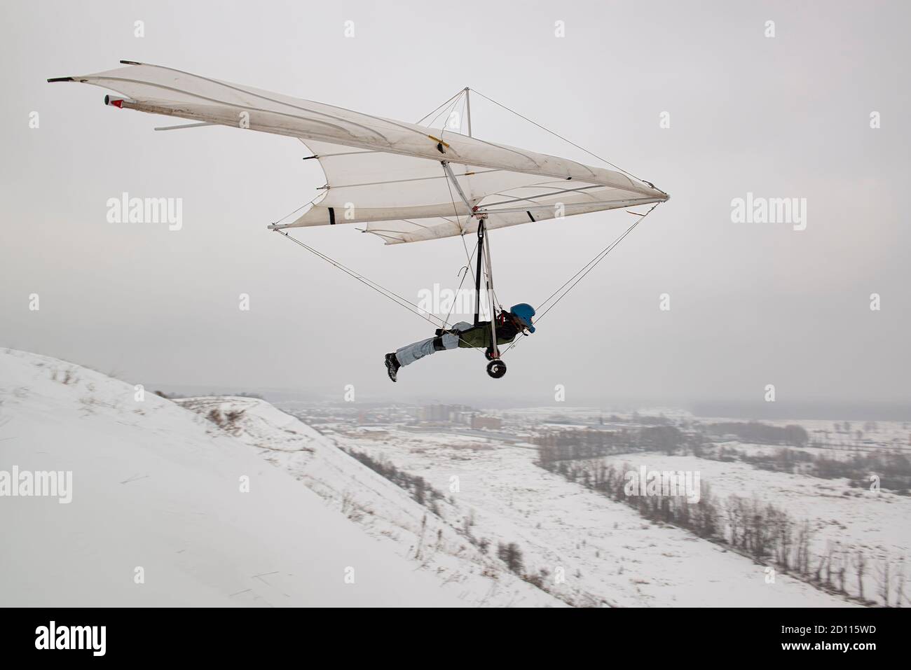 Student hang glider pilot on the training hill. Hang glider wing silhouette Stock Photo