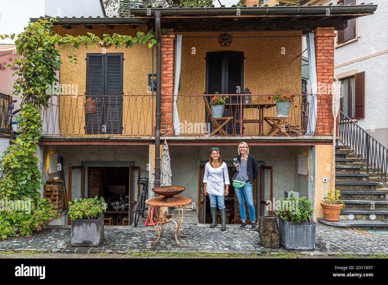 Culinary tour on Lake Lugano in Ticino, Circolo di Carona, Switzerland. The Cantine of Gabriella Monfredini in Melide. The cellars of the former natural cellar now house a kitchen and a dining room with a long table Stock Photo