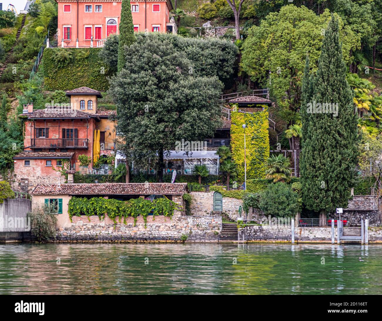 Culinary tour on Lake Lugano in Ticino, Circolo di Carona, Switzerland. In Morcote there is also the Parco Scherer. A sculpture park and botanical garden. Here almost near the shore stands an overgrown bird tower. Today a sculpture of a special kind, which reminds of the capture of the songbirds in Ticino Stock Photo