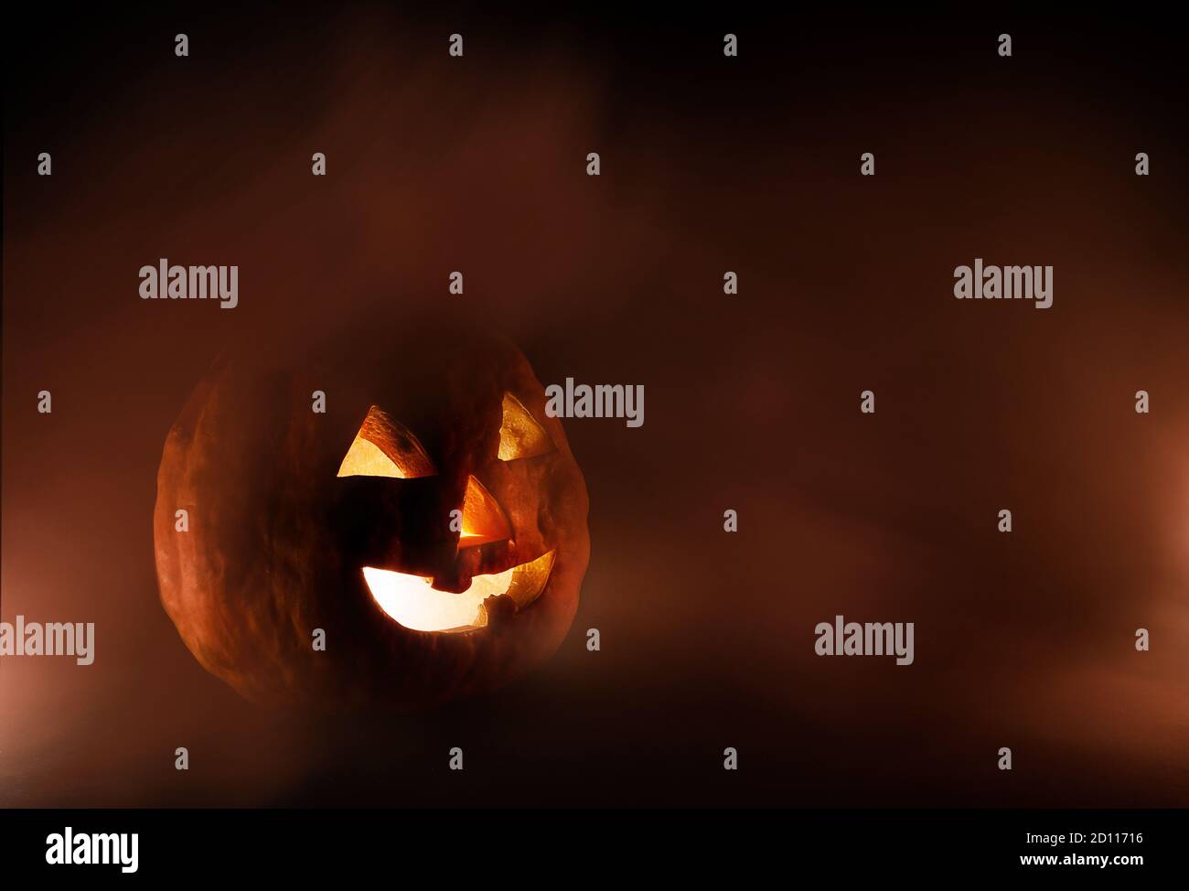 Jack o Lantern on a black background and with some fog Stock Photo - Alamy