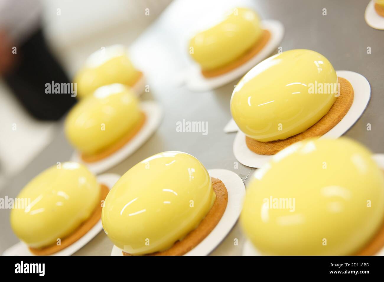 Decorates glazed pastries waits for a decorative elements. The process
