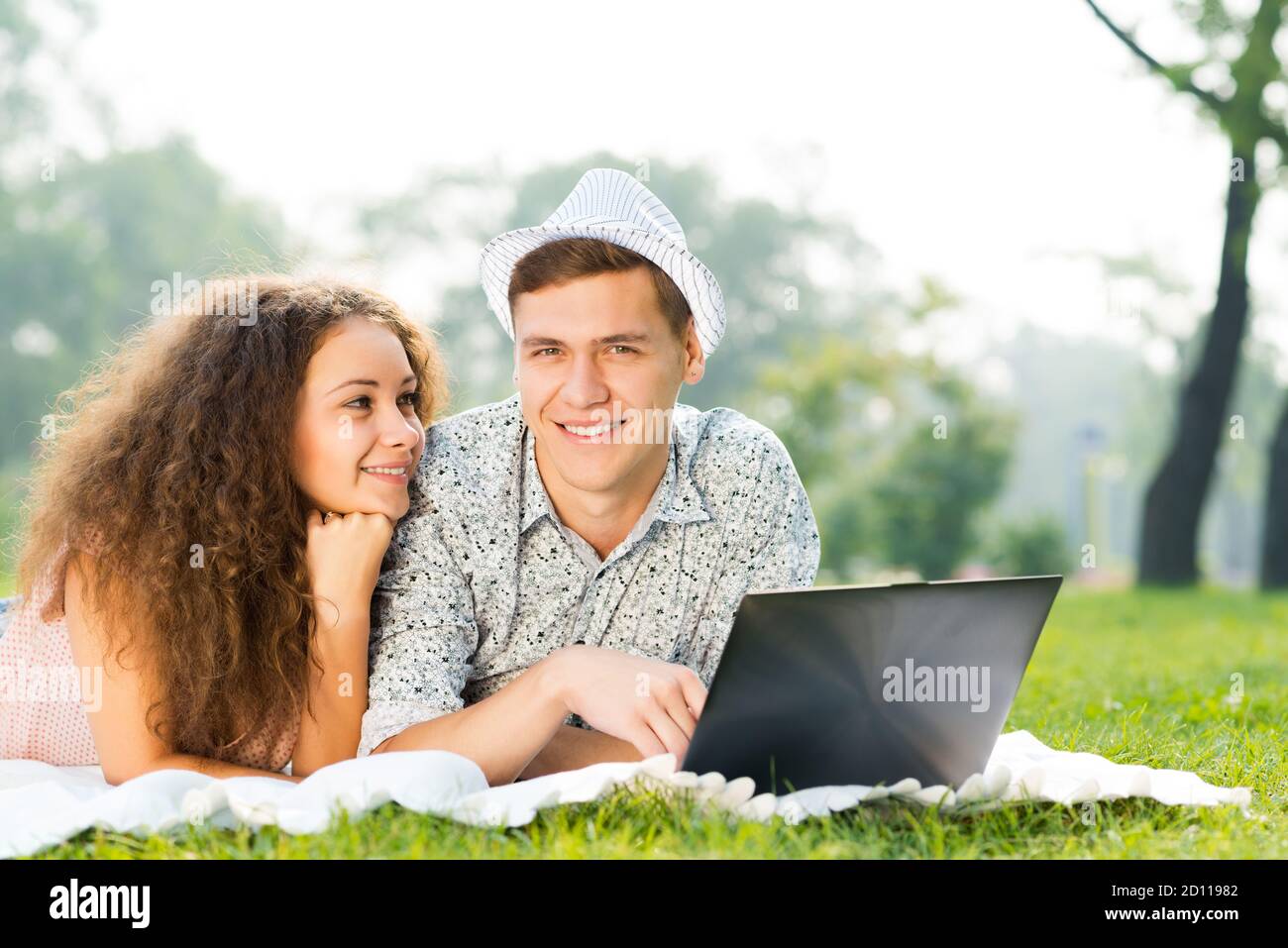 Man Woman Laptop Smiling Lying Happiness Grass Two People High Resolution Stock Photography And Images Alamy