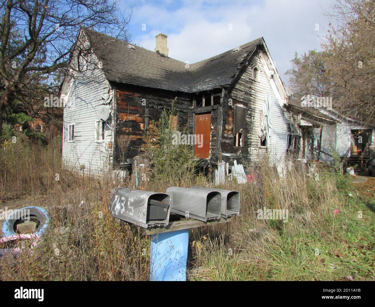 Three mailboxes in front of a burntout home in Detroit's Delray