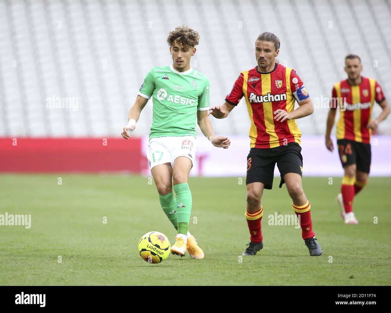 Adil Aouchiche of Saint-Etienne, Yannick Cahuzac of Lens during the French championship Ligue 1 football match between RC Lens and AS Saint Etienne (A Stock Photo