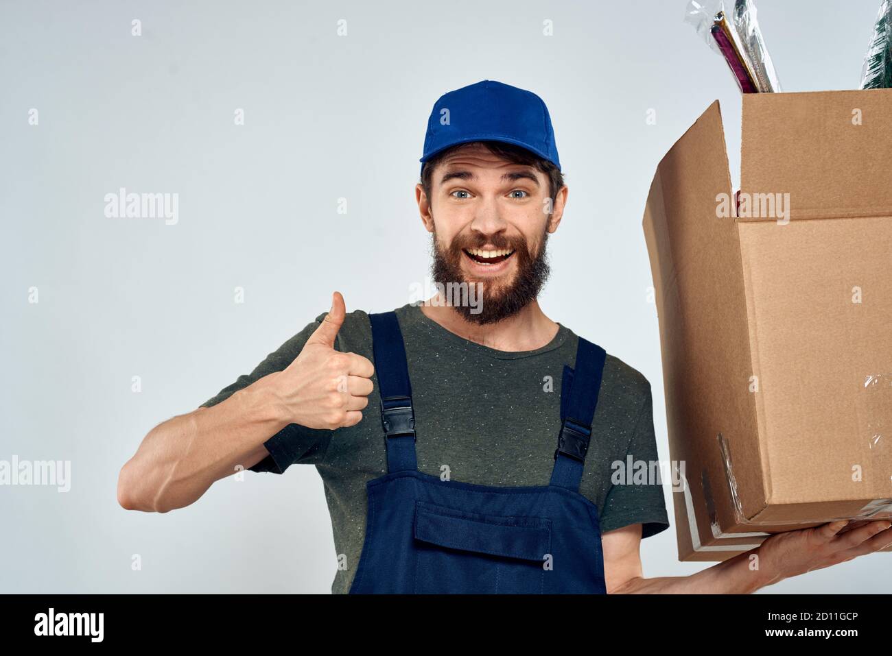 Male worker loading delivery boxes in hands packing lifestyle Stock