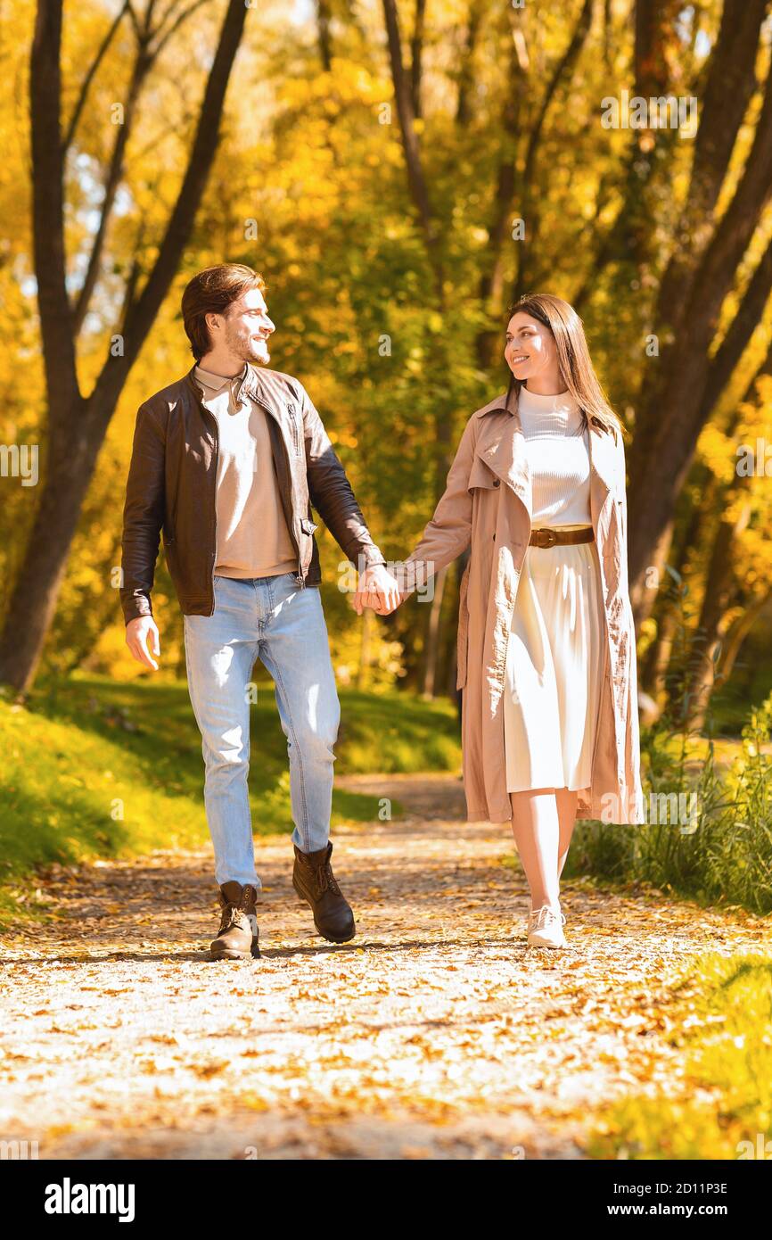 Young couple enjoying sunny autumn day in forest Stock Photo