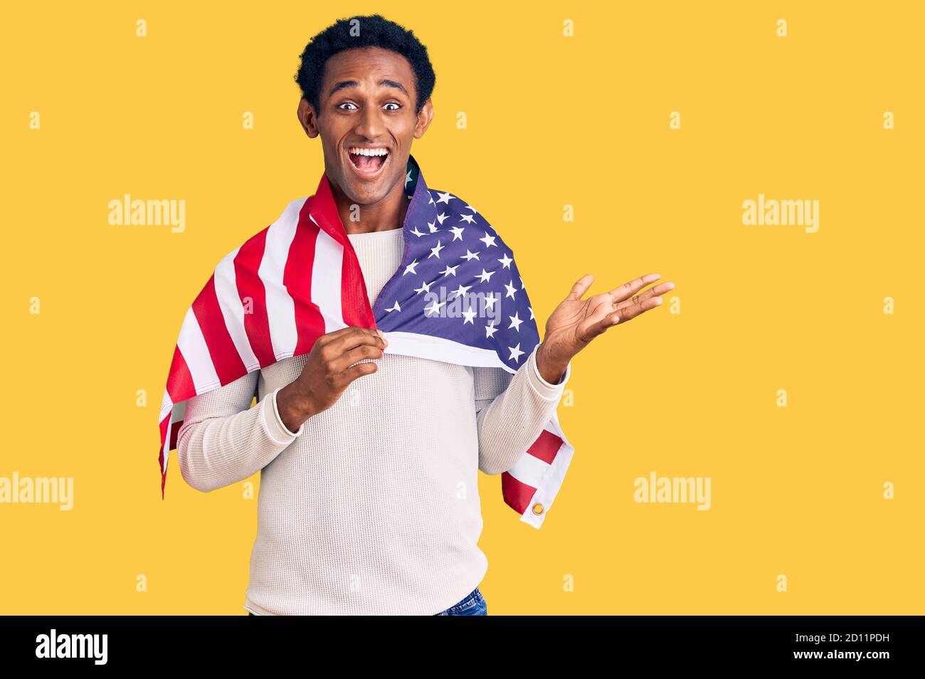 African handsome man holding united states flag celebrating victory ...