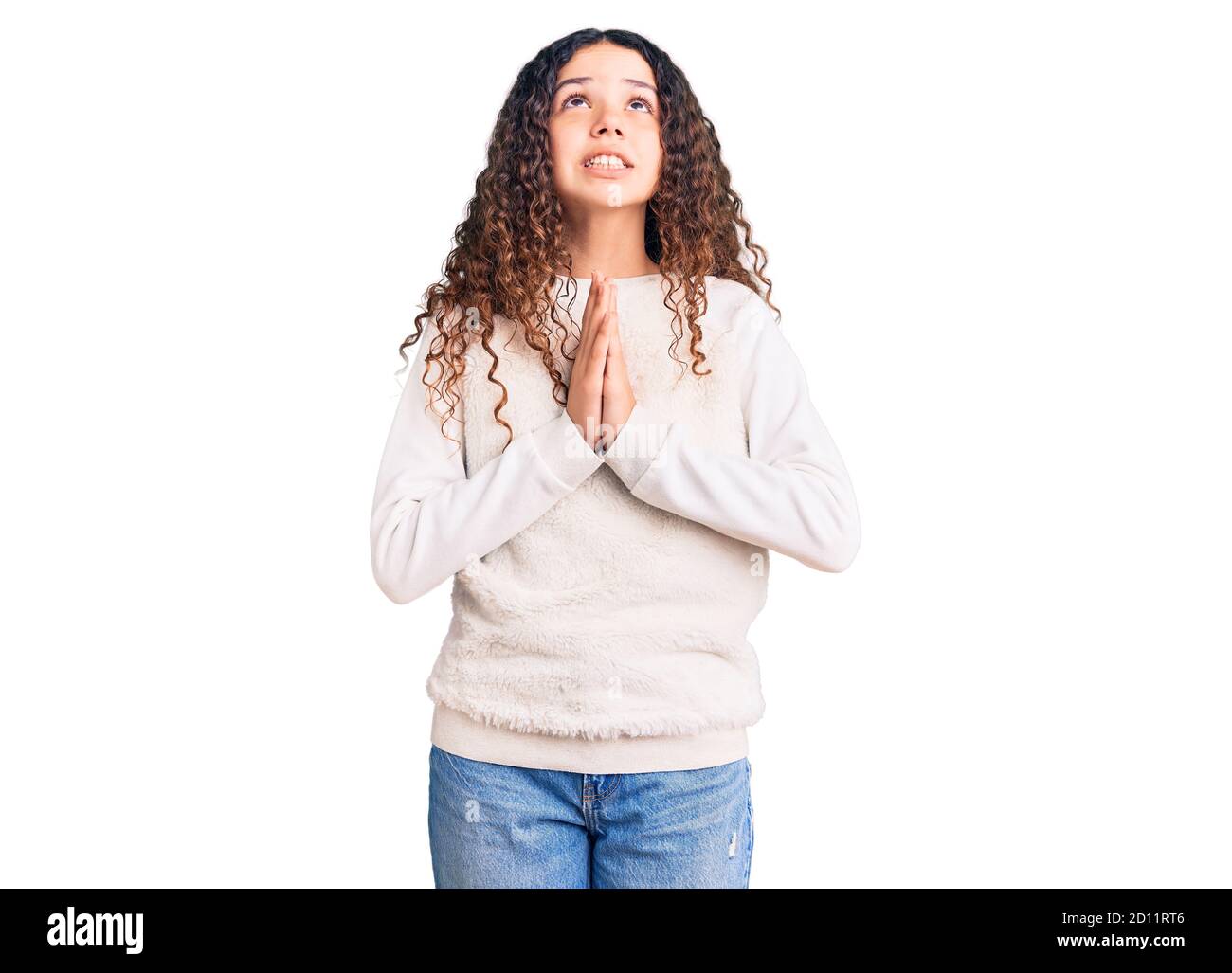 Beautiful kid girl with curly hair wearing casual clothes begging and ...