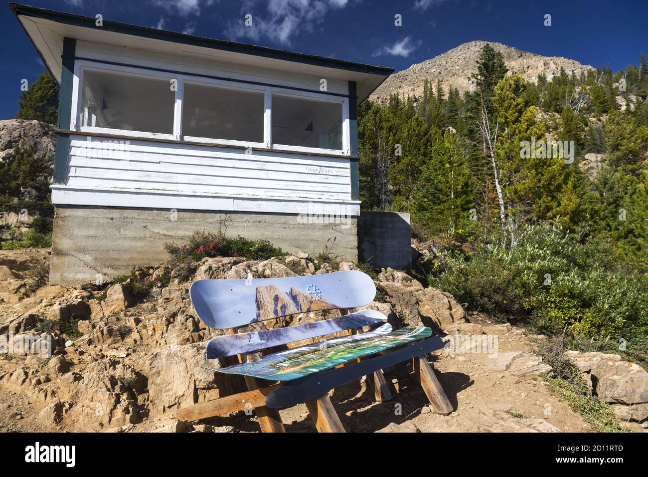 Old Paget Fire Lookout Wood Log Cabin Exterior. Multi Colored Wooden Ski Boards Bench. Yoho National Park Landscape View, Canadian Rocky Mountains Stock Photo