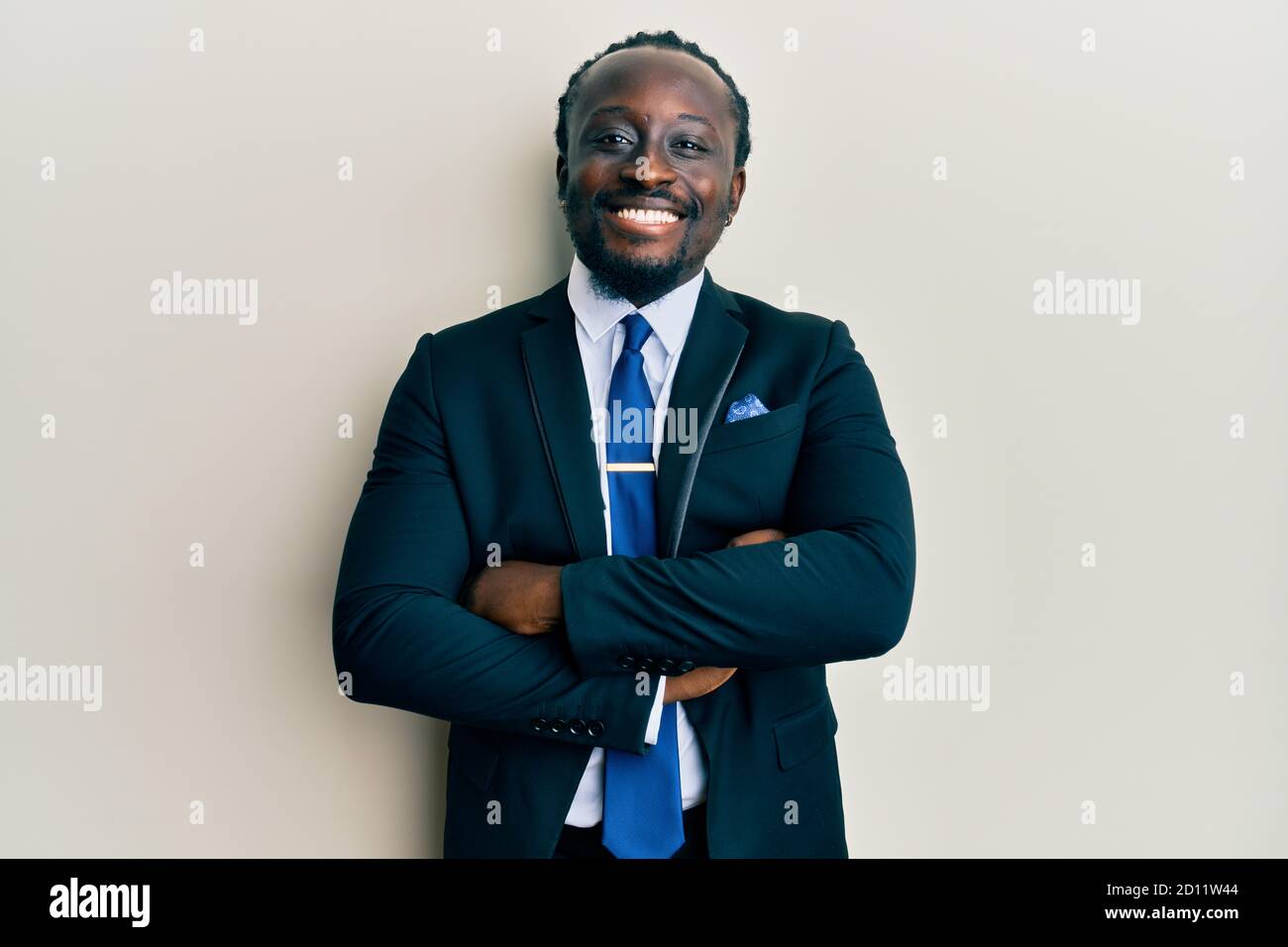 Handsome young black man wearing business suit and tie happy face ...