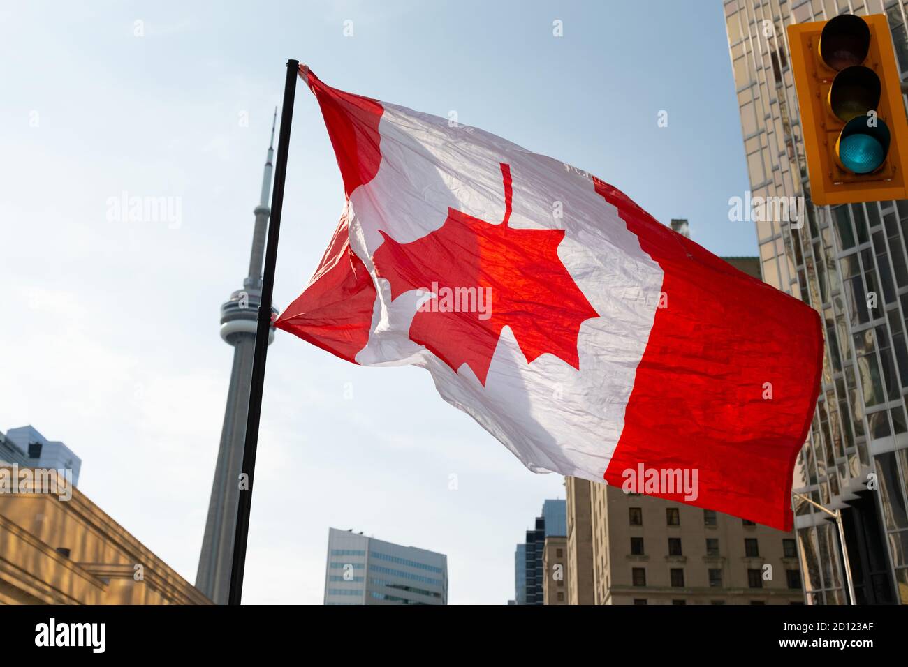 A Canada Flag is flown upside-down at a protest in Toronto, Ontario, to signify a nation in distress at the second 'March for Freedom' from COVID-19. Stock Photo