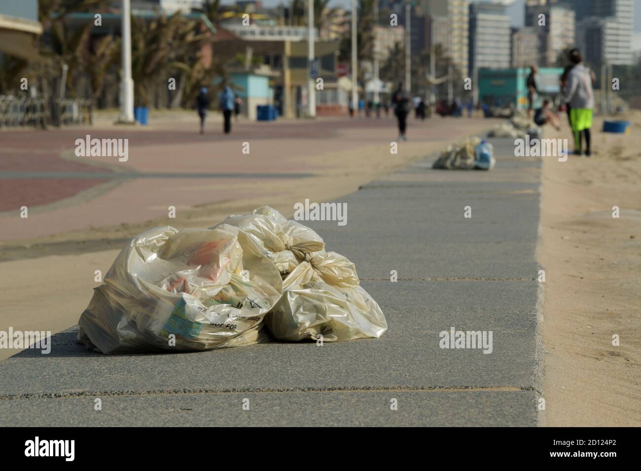Plastic pollution, bin liners filled with litter collected on beach