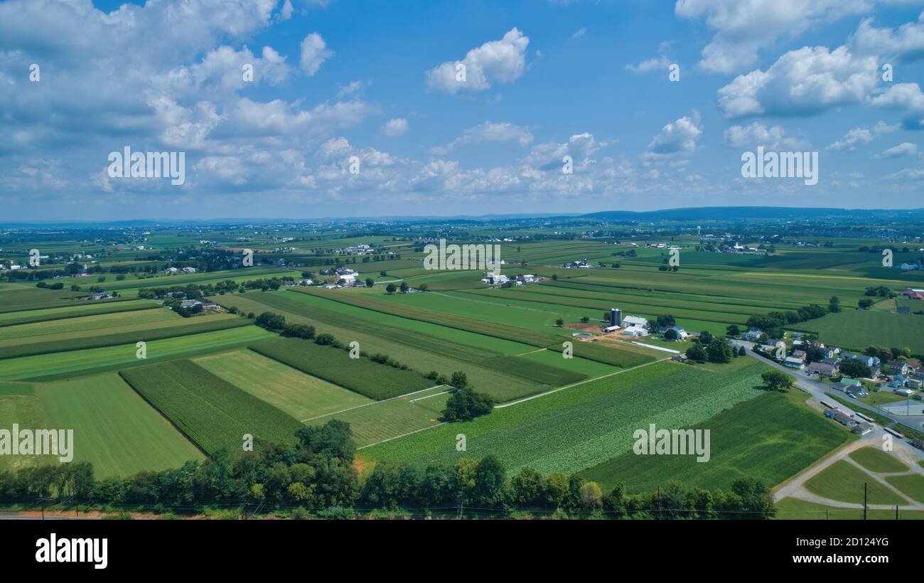 Aerial view of farm lands in summer with blue skies and white fluffy ...