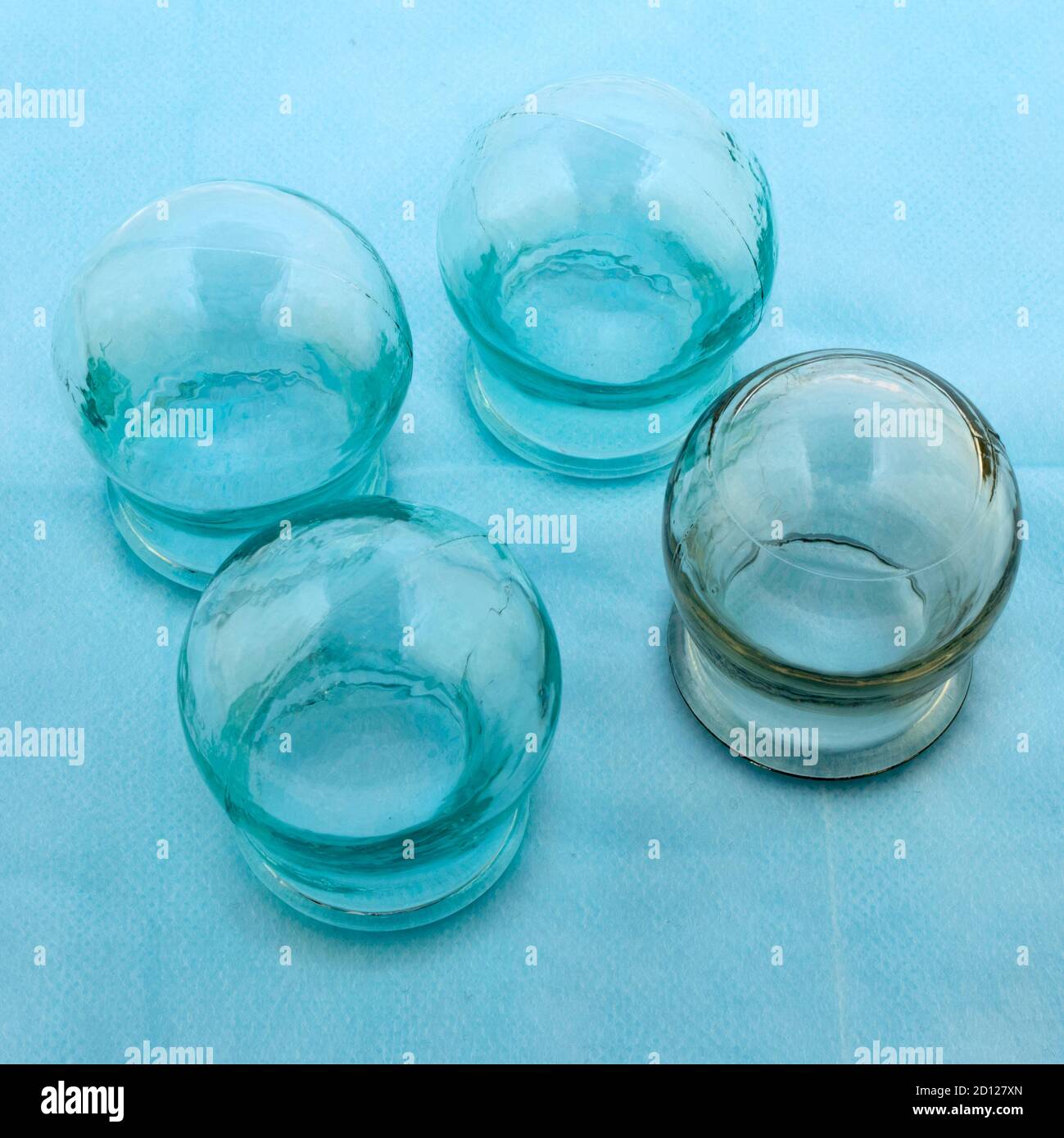 traditional medicine, glass, massage medical banks on a blue medical sheet Stock Photo Alamy