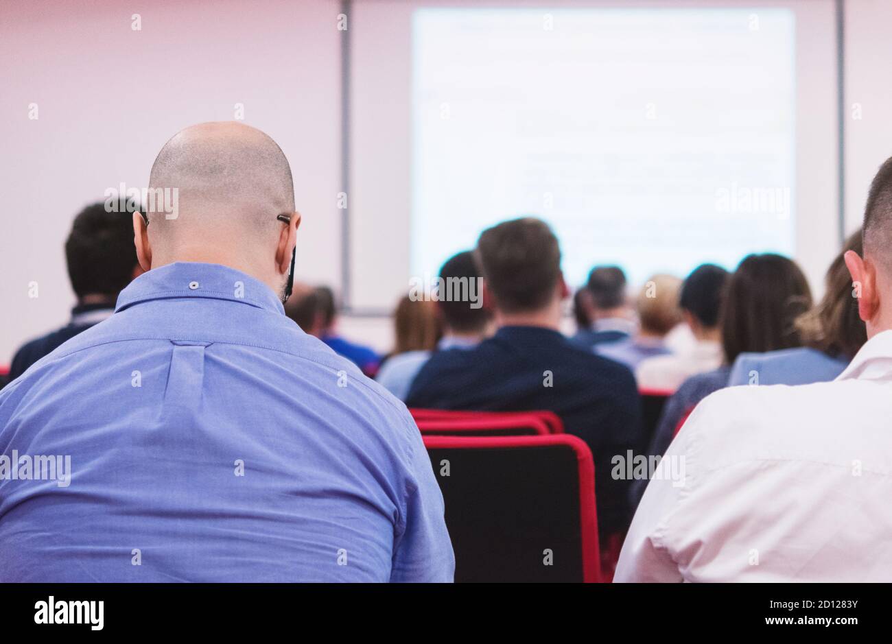 Business executive delivering presentation to colleagues during meeting ...