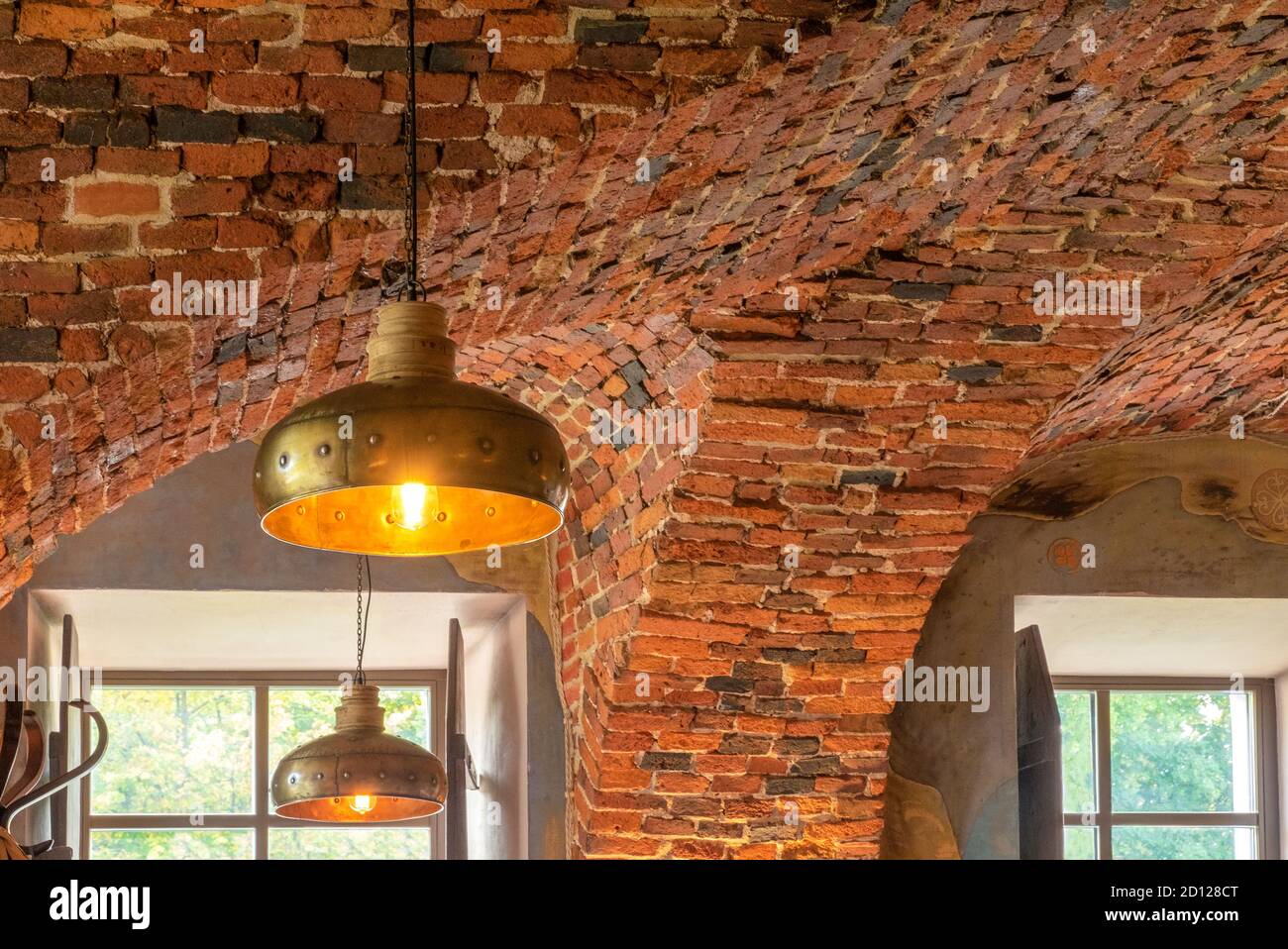 Retro style copper, brass or bronze luminaire on red brick vaulted ceiling.  Horizontal orientation, selective focus Stock Photo - Alamy