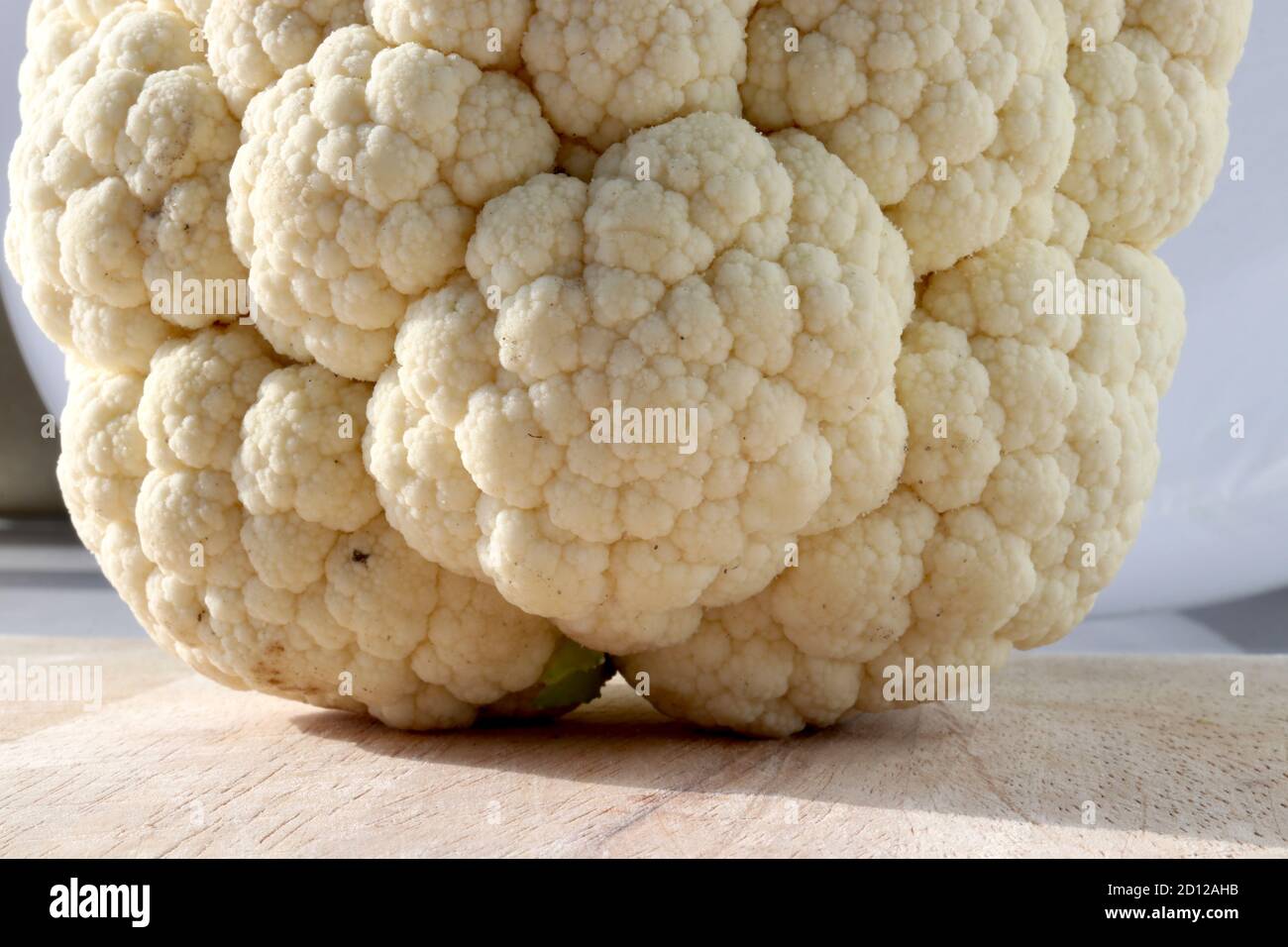 Cauliflower on wooden chopping board Stock Photo