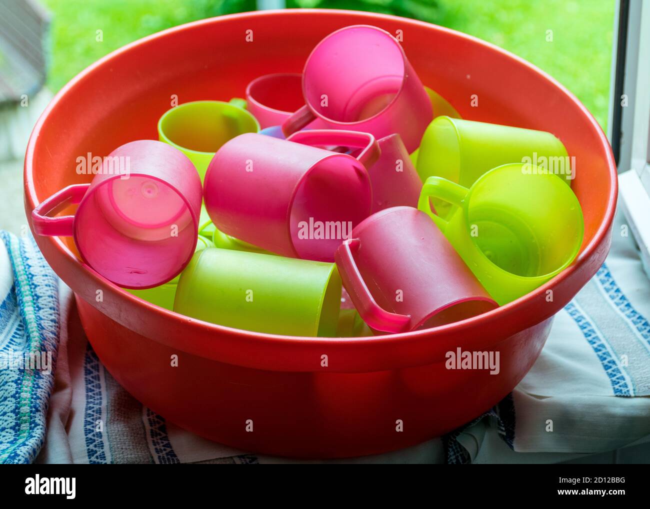 school kitchen canteen, colored plastic cups, canteen equipment, catering establishment, Stock Photo