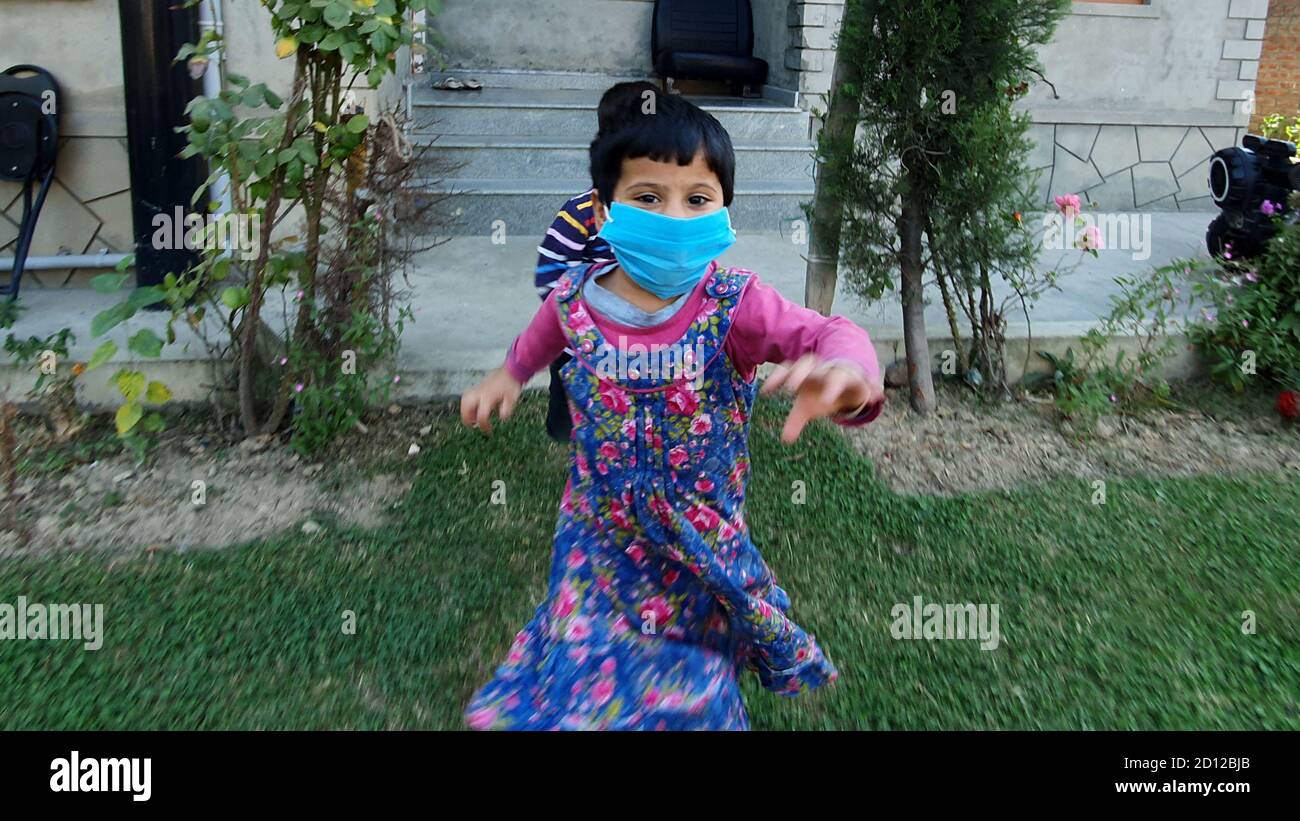 Kids play wearing mask after the coronavirus lockdown in asian