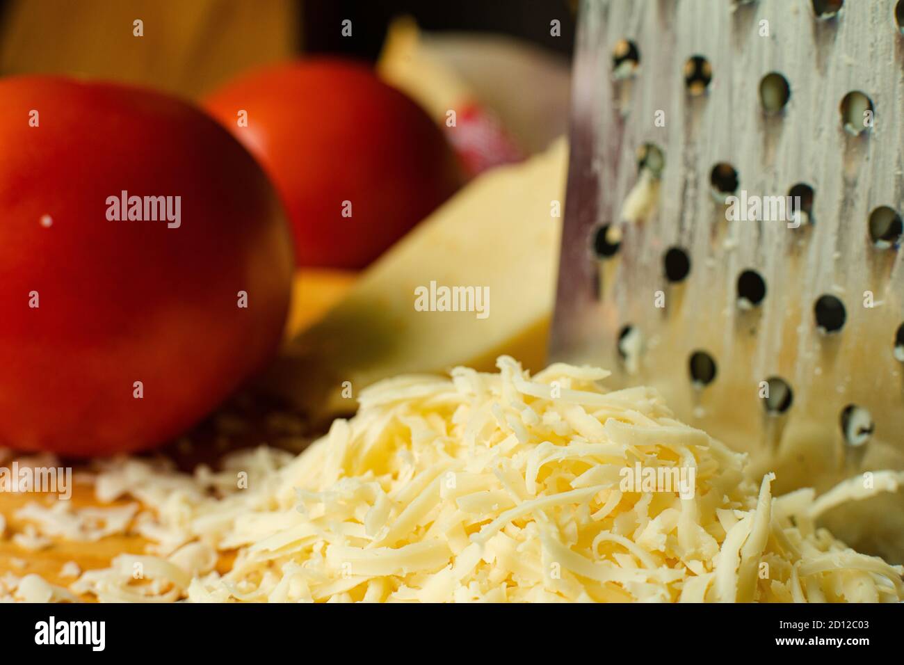 Grated cheese and tomatoes in close-up. Stock Photo