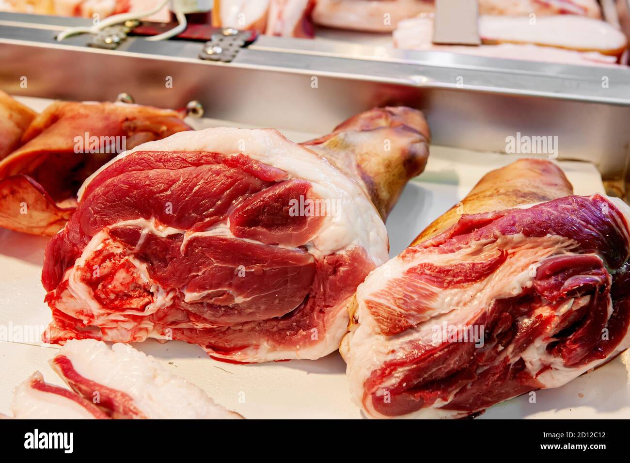 Selection of quality meat in a butcher shop. Raw pork knuckles are on