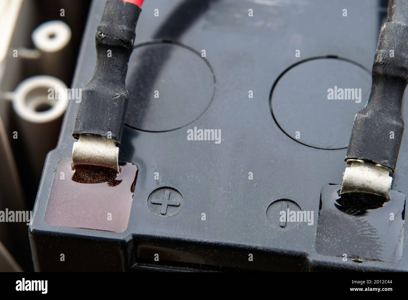 black battery with wires attached to its terminals Stock Photo - Alamy