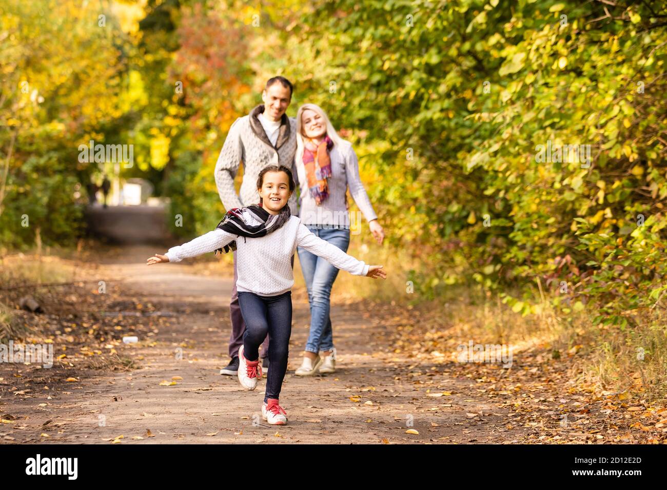 happy family walking in the autumn park Stock Photo - Alamy
