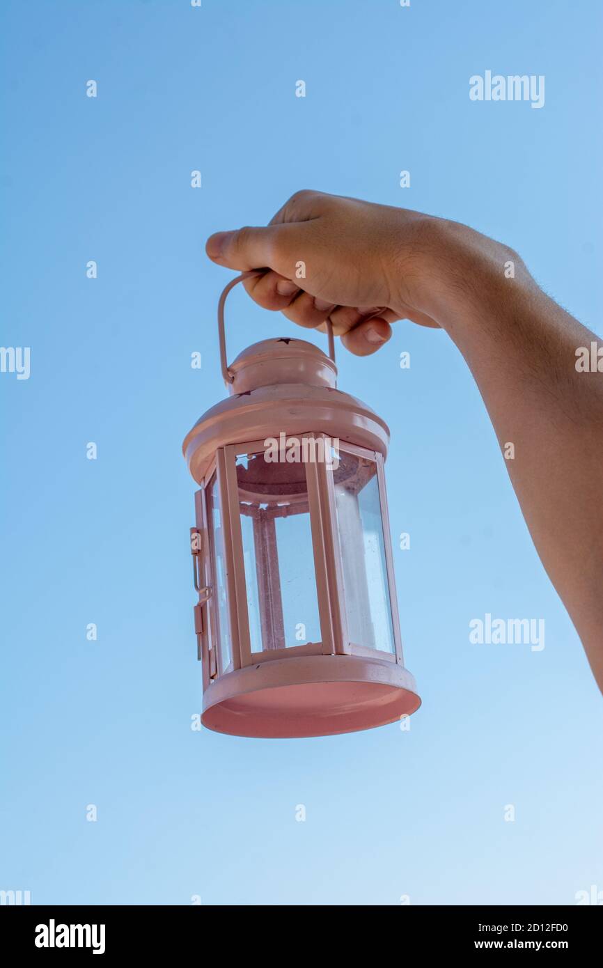 Old retro style lantern made of metal in hand Stock Photo - Alamy