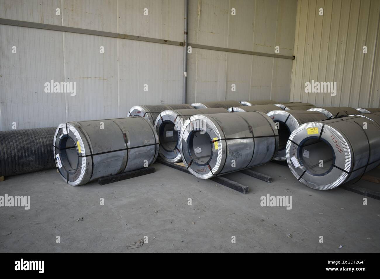 Rolls of steel sheet stored in warehouse; galvanized steel coil in the Duct Factory. Packed rolls of steel sheet, Cold rolled steel coils. Stock Photo
