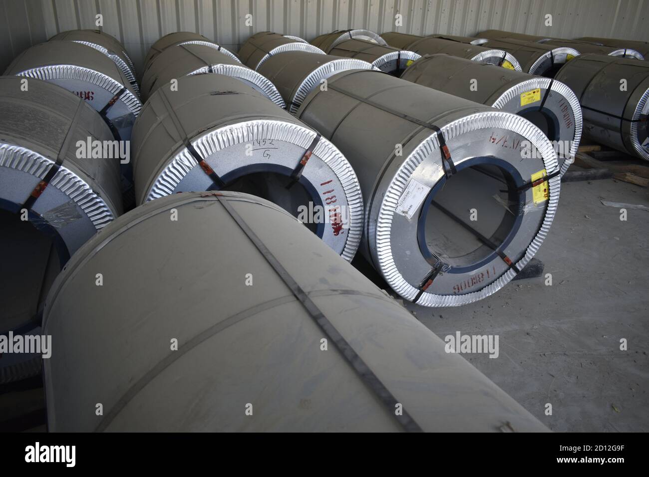 Rolls of steel sheet stored in warehouse; galvanized steel coil in the Duct Factory. Packed rolls of steel sheet, Cold rolled steel coils. Stock Photo